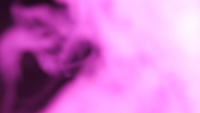 Emitting beautiful juicy multi-colored hookah smoke on a black background close-up