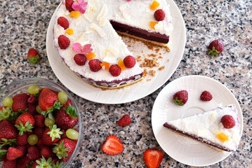 Home made delicious strawberry mousse cake on a stone background.