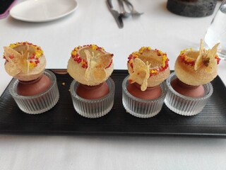 cupcakes on a plate
Starter - arugula pani puri, feta cream, poached pears