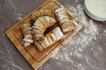 Tasty puff pastry dessert with fruit jam covered with sugar powder.