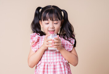 Image of Asian child drinking milk on background