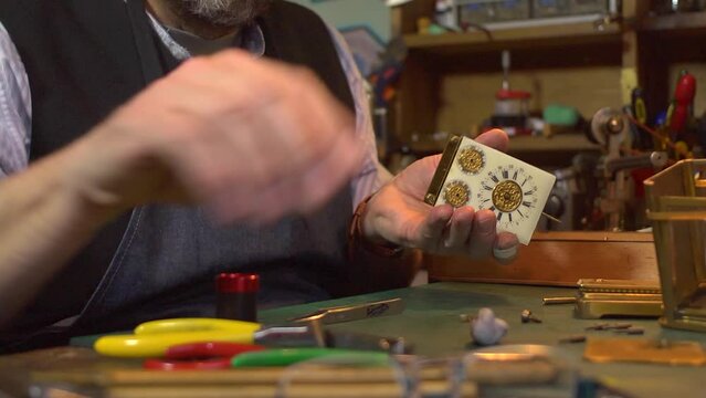 Clockmaker working on a carriage clock - tapping with hammer