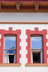 Two View Windows with Sky Reflections at an Art Deco Restored Building.
