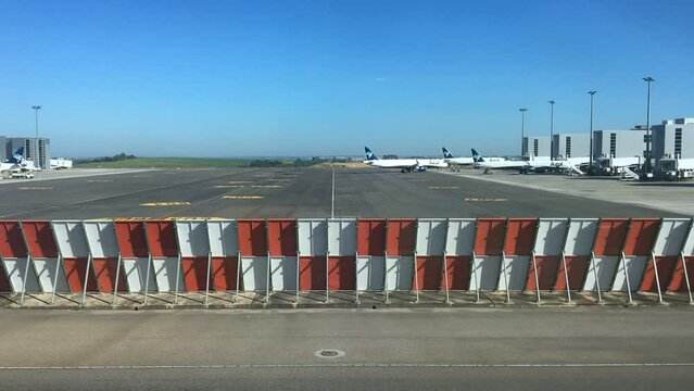 Campinas, Viracopos Airport, Brazil - March 24, 2022: Time lapse of planes taxiing after boarding passengers and heading for takeoff on airport runway on sunny day.