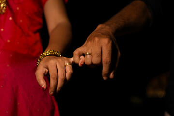 newly married male and female hands holding fingers