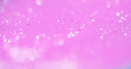 Bokeh light overlay. Blur glow. Sequin reflection. Defocused white shiny circles glare on pastel pink color glamour abstract background.