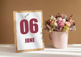 june 6. 6th day of month, calendar date.Bouquet of dead wood in pink mug on desktop.Cork board with calendar sheet on white-beige background. Concept of day of year, time planner, summer month