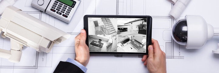 Person Watching Footage On Digital Tablet