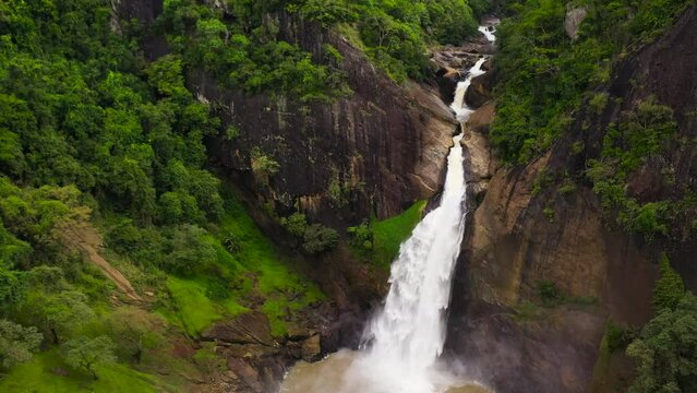 Dunhinda Falls waterfall in a mountain gorge in the tropical jungle. Sri Lanka. Waterfall in the tropical forest.