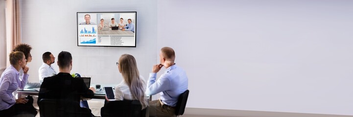 Businesspeople Video Conferencing In Boardroom