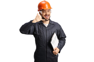 Factory worker in a uniform and helmet gesturing a phone call sign