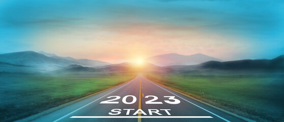 New start of the new year 2023.  Starting to new year.  2023 written on the road in the middle of asphalt road at sunset. Goals,plan,opportunity and new business or life changing for the next year. - obrazy, fototapety, plakaty