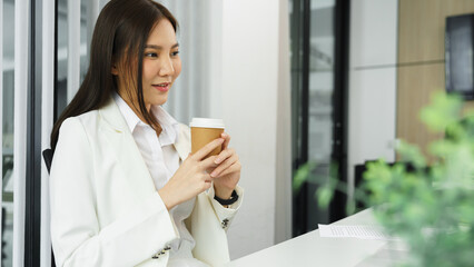 Confidence woman concept, Businesswoman drinking coffee and watching movie to relax after work hard