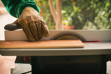 Hands Of A Man Making Custom Furniture Wood Parts On Machine Tool Called Table Saw In Woodworking...