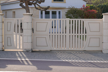 Aluminum large beige car gate of modern house door access in street view