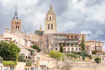 views of the gothic and renaissance cathedral of Segovia with tourists walking under its arches in Segovia