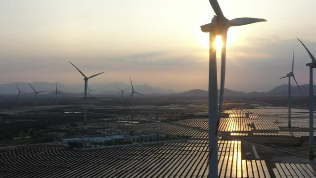 Aerial view of wind mill and Solar panel, photovoltaic, alternative electricity source - concept of sustainable resources on a sunny day, Ninh Thuan, Vietnam