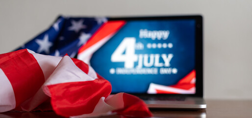 laptop with Inscription Happy independence day on usa flag.