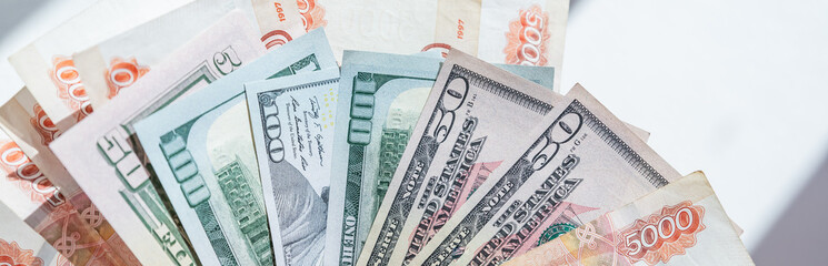 Different money in banknotes of 50,100 dollars and Russian rubles. rouble and USA dollar banknotes.Russia disconnected from swift.Concept of trade war,american and european sanctions against Russia