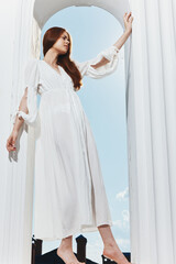 pretty woman in white dress in the window opening light luxury