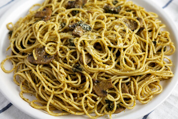 Homemade Spinach Mushroom Pesto Spaghetti on a Plate, side view. Close-up.