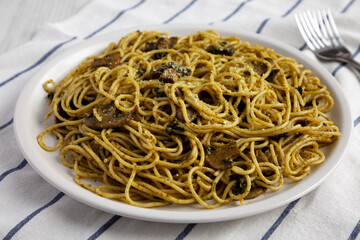 Homemade Spinach Mushroom Pesto Spaghetti on a Plate, low angle view. Close-up.