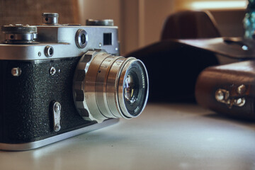 Film camera unknown model. Manual object. In the background is a leather case of cabura