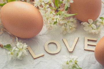 still life with  eggs and flowers and wooden letters LOVE