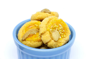 cashew nuts cookie are in the cup isolated on white background, close-up shoot