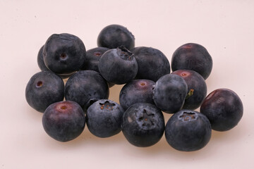 Closeup on a small pile of European blueberries, Vaccinium myrtillus against a white background