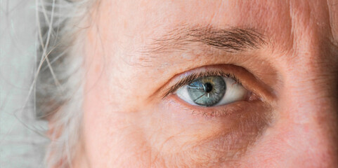 close up of macro shot elderly man two brown eyes with pupil and iris - obrazy, fototapety, plakaty
