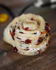 hands of a person preparing a dough. close up of a person working on a kitchen. Woman making dough. Raisins  on the dough