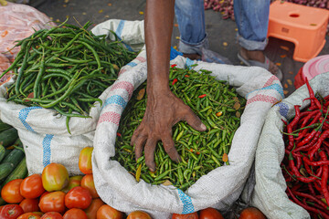 Traders sell red chilies, green chilies and tomatoes in traditional markets. Chili is useful for maintaining heart health, helps lower blood sugar and kills cancer cells.