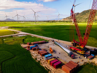 Aerial view of wind turbine under construction with a crane to generate sustainable alternative...