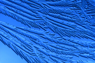 Gold patterns from frost on glass as a background.