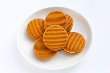 Custard cream sandwich biscuits on white background.
