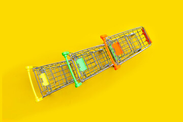 Shopping trolley or Shopping cart on yellow background.