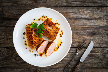 Roasted pork loin on wooden table
