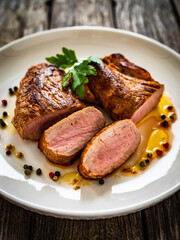 Roasted pork loin on wooden table
