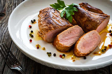 Roasted pork loin on wooden table
