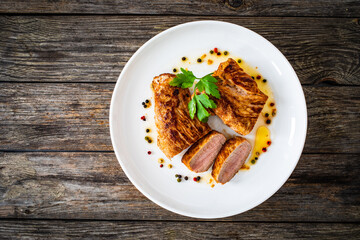 Roasted pork loin on wooden table
