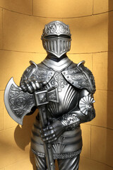 Iron knight on background of wall