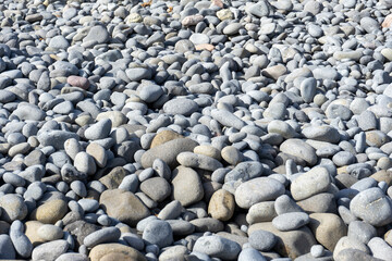 TEXTURE OF ROUND STONES ON THE BEACH