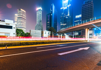 Fototapeta na wymiar Buildings in the night view of the city and cars driving on the expressway