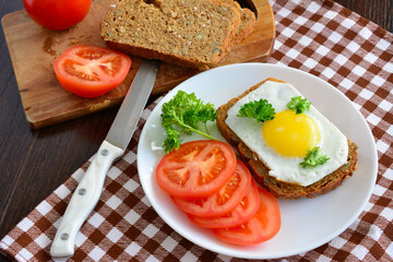 healthy breakfast with wholegrain sandwich and sliced tomatoes, close-up