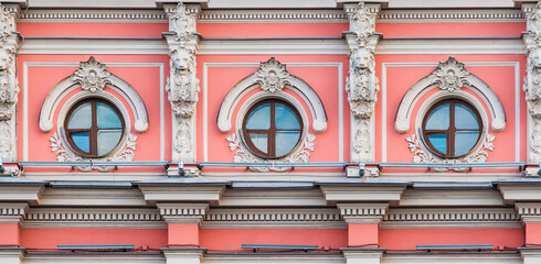 Three windows in a row on the facade of the urban historic apartment building front view, Saint Petersburg, Russia  © dr_verner
