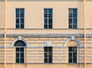 Several windows in a row on the facade of the urban historic apartment building front view, Saint Petersburg, Russia
