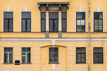 Many windows in a row on the facade of the urban historic apartment building front view, Saint Petersburg, Russia
