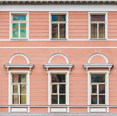 Several windows in a row on the facade of the urban historic apartment building front view, Saint Petersburg, Russia
