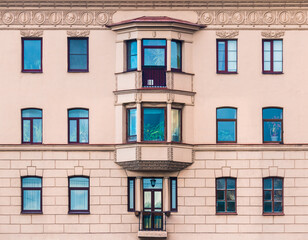 Many windows in a row on the facade of the urban historic apartment building front view, Saint Petersburg, Russia
